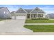 Attractive home exterior with a blend of stone and siding, complemented by green lawn at 1107 Mccray Ln, Westfield, IN 46074