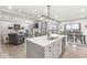 Kitchen island with sink and seating overlooks living and dining areas at 1107 Mccray Ln, Westfield, IN 46074