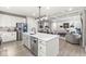 Open concept kitchen with island, stainless steel appliances, and modern lighting fixtures at 1107 Mccray Ln, Westfield, IN 46074