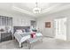 Spacious main bedroom with tray ceiling, soft carpet, and access to the bathroom at 1107 Mccray Ln, Westfield, IN 46074