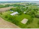 Expansive aerial shot showcasing the property's fields, horse training area, and large barn, ideal for equestrian pursuits at 11823 E 200 S, Zionsville, IN 46077