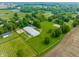 Aerial view highlighting the property's horse training facilities, including a well-maintained barn and expansive grassy areas at 11823 E 200 S, Zionsville, IN 46077
