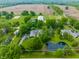 Aerial view of a private estate with a pond, barn, lush landscaping, and acreage at 11823 E 200 S, Zionsville, IN 46077