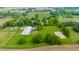 Sprawling equestrian estate featuring a vast field, horse training area, and extensive outbuildings, set amidst picturesque scenery at 11823 E 200 S, Zionsville, IN 46077