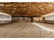 Bright and spacious indoor riding arena with a sanded floor and multiple horse stalls at 11823 E 200 S, Zionsville, IN 46077