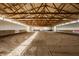 Large indoor arena with a sand floor and overhead wood beam support structure at 11823 E 200 S, Zionsville, IN 46077