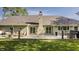 Backyard view showcases the deck with outdoor furniture, a grill, lush green lawn, and the house's exterior details and mature trees at 11823 E 200 S, Zionsville, IN 46077