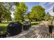 Spacious backyard showcasing a deck, patio furniture, and lush greenery, perfect for outdoor entertaining at 11823 E 200 S, Zionsville, IN 46077