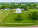 Aerial view of the barn and surrounding green pastures on the expansive horse property at 11823 E 200 S, Zionsville, IN 46077