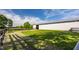 Exterior view of a white barn set against a backdrop of green grass and trees at 11823 E 200 S, Zionsville, IN 46077