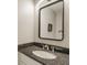 Bathroom featuring granite countertop, undermount sink, and modern mirror at 11823 E 200 S, Zionsville, IN 46077