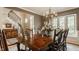 Formal dining room boasts a large wooden table, chandelier, and natural light at 11823 E 200 S, Zionsville, IN 46077