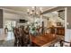 Open-concept dining room features a large table with seating for ten and view to living room at 11823 E 200 S, Zionsville, IN 46077