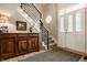 Inviting foyer features a staircase with modern iron railing and warm wood flooring at 11823 E 200 S, Zionsville, IN 46077