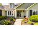 Welcoming front entrance with an American flag, beautiful landscaping and a black front door at 11823 E 200 S, Zionsville, IN 46077