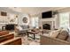 Cozy living room with a brick fireplace, large windows, and stylish furnishings at 11823 E 200 S, Zionsville, IN 46077