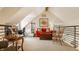 Bright living room featuring high ceilings, a red sofa, and a small desk providing a cozy and functional space at 11823 E 200 S, Zionsville, IN 46077