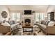 Bright living room featuring a fireplace, natural light, and comfortable sofas for relaxing at 11823 E 200 S, Zionsville, IN 46077