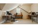 Functional home office space with dual desks and a comfortable ergonomic chair under an angled ceiling at 11823 E 200 S, Zionsville, IN 46077