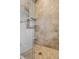 A fully tiled shower features a glass enclosure, built-in shelves, and sleek hardware, offering a spa-like experience at 11823 E 200 S, Zionsville, IN 46077