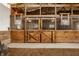 Horse stalls with wooden doors and metal bars, offering ample space and ventilation at 11823 E 200 S, Zionsville, IN 46077