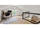 Versatile attic space with a desk and chair setup, a checkered rug, and a view of the staircase at 1205 N Temple Ave, Indianapolis, IN 46201