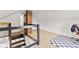 Upper level view of the attic featuring a staircase, a railing, and ample carpeted space for flexible use at 1205 N Temple Ave, Indianapolis, IN 46201