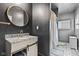 Chic bathroom showcasing black walls, granite vanity, and decorative tile flooring leading to the shower at 1205 N Temple Ave, Indianapolis, IN 46201