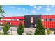 Exterior view of a commercial building, featuring a red and black facade with trees on a sunny day at 1205 N Temple Ave, Indianapolis, IN 46201