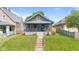 Charming home with a front porch and well-maintained lawn and inviting curb appeal at 1205 N Temple Ave, Indianapolis, IN 46201
