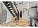 Bright hallway with modern staircase, wooden floors, and stylish decor at 1205 N Temple Ave, Indianapolis, IN 46201