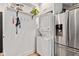 Convenient laundry area with stacked washer and dryer and storage shelves at 1205 N Temple Ave, Indianapolis, IN 46201