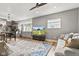 Open concept living room and kitchen with stainless steel appliances, hardwood floors, and a colorful rug at 1205 N Temple Ave, Indianapolis, IN 46201