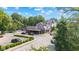 Street view featuring a commercial building with parking, sidewalk, and street with trees on a partly cloudy day at 1205 N Temple Ave, Indianapolis, IN 46201