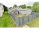Aerial view of a fully fenced backyard with a grey shed and green lawn at 1219 Citation W Cir, Lebanon, IN 46052