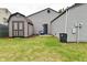 View of the house, shed and blue chair in the backyard with a green lawn at 1219 Citation W Cir, Lebanon, IN 46052