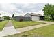 Scenic front yard showcases a grey fence, green grass, and a grey house at 1219 Citation W Cir, Lebanon, IN 46052