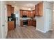 Spacious kitchen featuring wood cabinetry, stainless steel appliances, and modern flooring at 1219 Citation W Cir, Lebanon, IN 46052