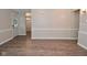Open-concept room showcasing wainscoting and a glimpse of the front entry at 1219 Citation W Cir, Lebanon, IN 46052