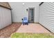 Cozy patio area with blue chair and exterior door at 1219 Citation W Cir, Lebanon, IN 46052