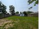 Picture of the backyard surrounded by a wooden fence, featuring a garage and green grass at 1359 S Mulberry St, Martinsville, IN 46151