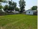 A view of a lush green backyard enclosed by a wood fence, with trees and a covered gazebo visible at 1359 S Mulberry St, Martinsville, IN 46151