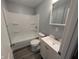 A clean bathroom featuring a tub and shower combo, sink, and vanity with modern faucet at 1359 S Mulberry St, Martinsville, IN 46151