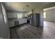 Modern kitchen with stainless steel appliances, white cabinets, and stylish flooring at 1359 S Mulberry St, Martinsville, IN 46151