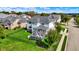 An aerial view of a light blue two-story home with a manicured lawn and backyard deck at 14458 Smickle Ln, Carmel, IN 46033