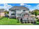 Backyard featuring a multi-story deck, green lawn, and fenced perimeter at 14458 Smickle Ln, Carmel, IN 46033