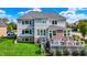 A backyard view of a two-story home with a walkout deck and well maintained lawn at 14458 Smickle Ln, Carmel, IN 46033