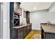 The finished basement features a bar area with custom cabinetry, a sink, and a granite countertop at 14458 Smickle Ln, Carmel, IN 46033