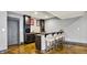 The wet bar features dark wood cabinetry, stone countertops and bar seating, offering plenty of space to entertain at 14458 Smickle Ln, Carmel, IN 46033