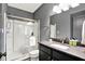 Bathroom featuring a glass shower enclosure, vanity with granite countertop and modern fixtures at 14458 Smickle Ln, Carmel, IN 46033